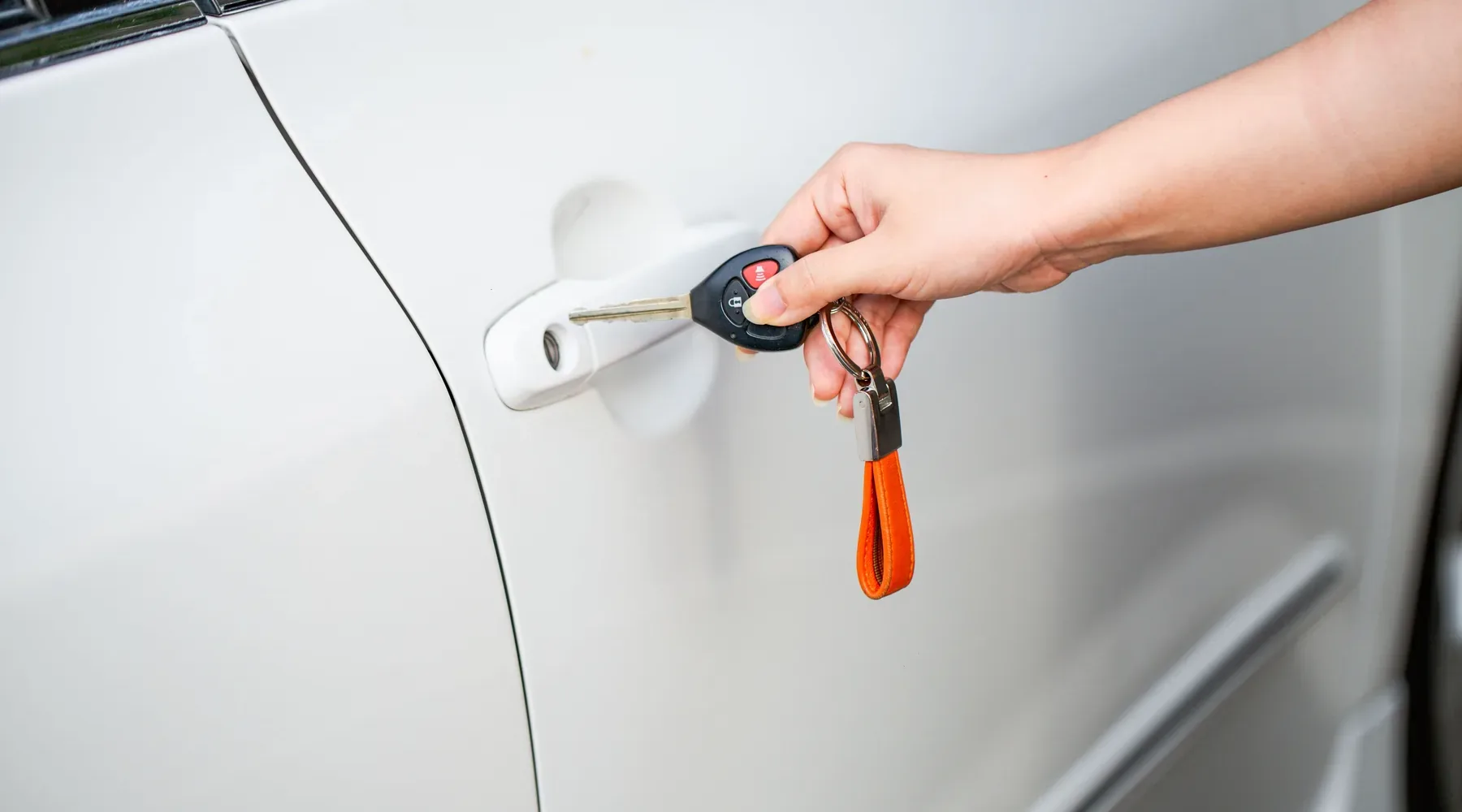 Car key held at a vehicle door