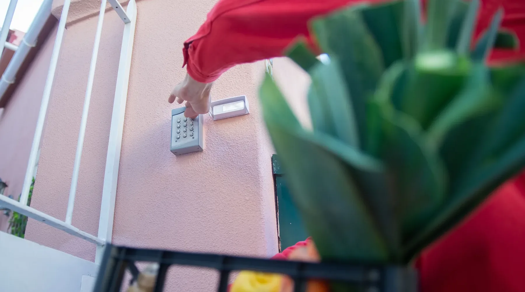 Person entering a code on an access keypad