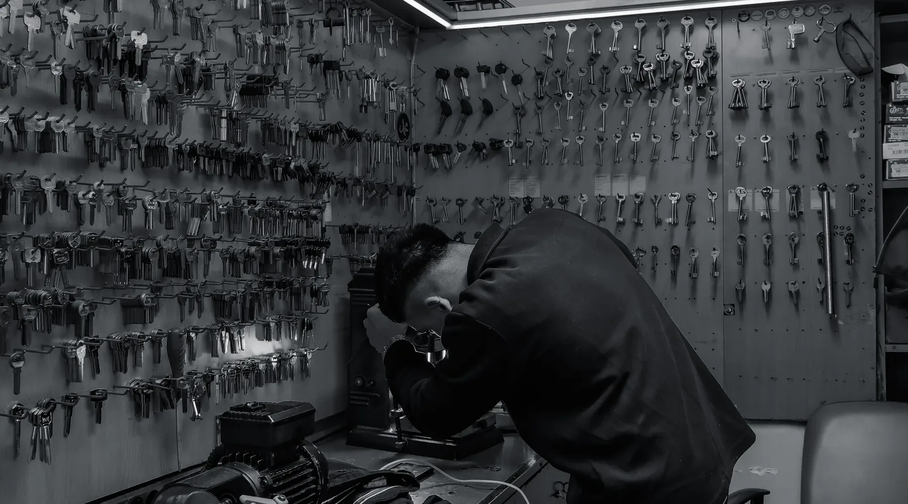 Locksmith working with lock hardware at a bench
