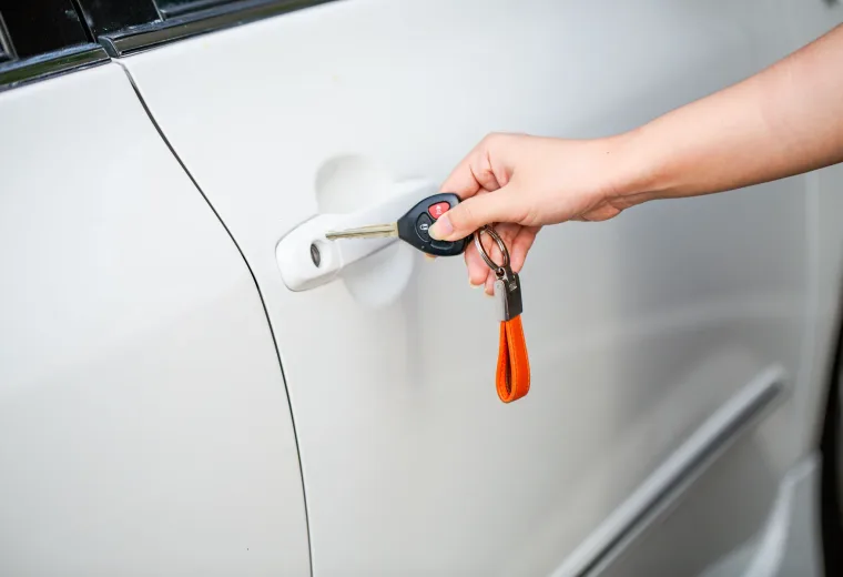 Car key held at a vehicle door