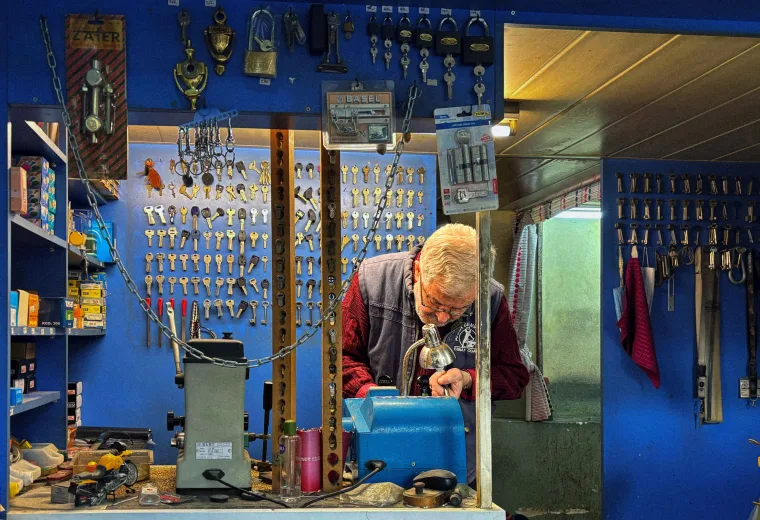 Locksmith working with keys at a workshop bench
