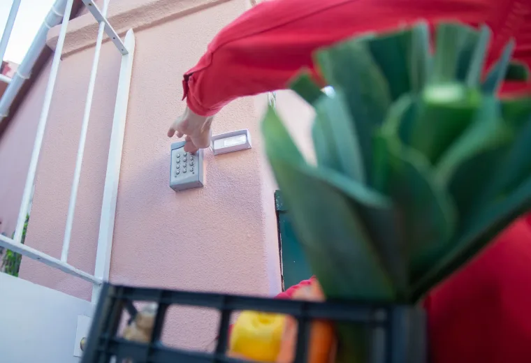 Person entering a code on an access keypad