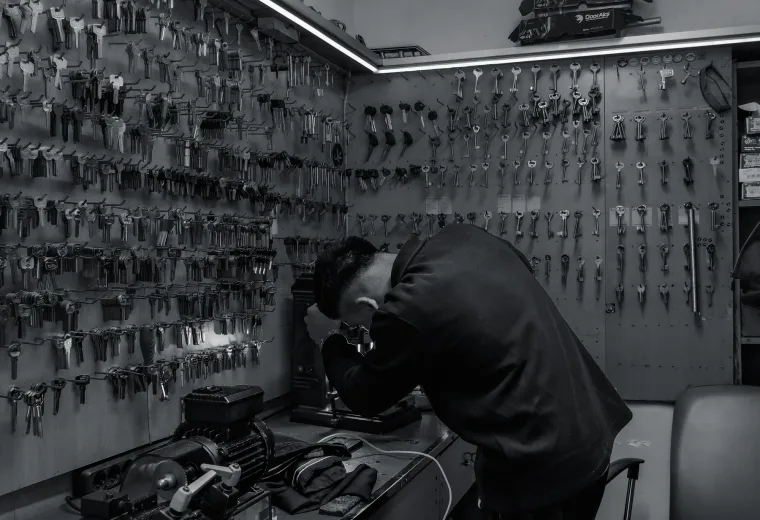 Locksmith working with lock hardware at a bench